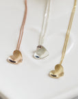 Tiny gold concave heart necklace