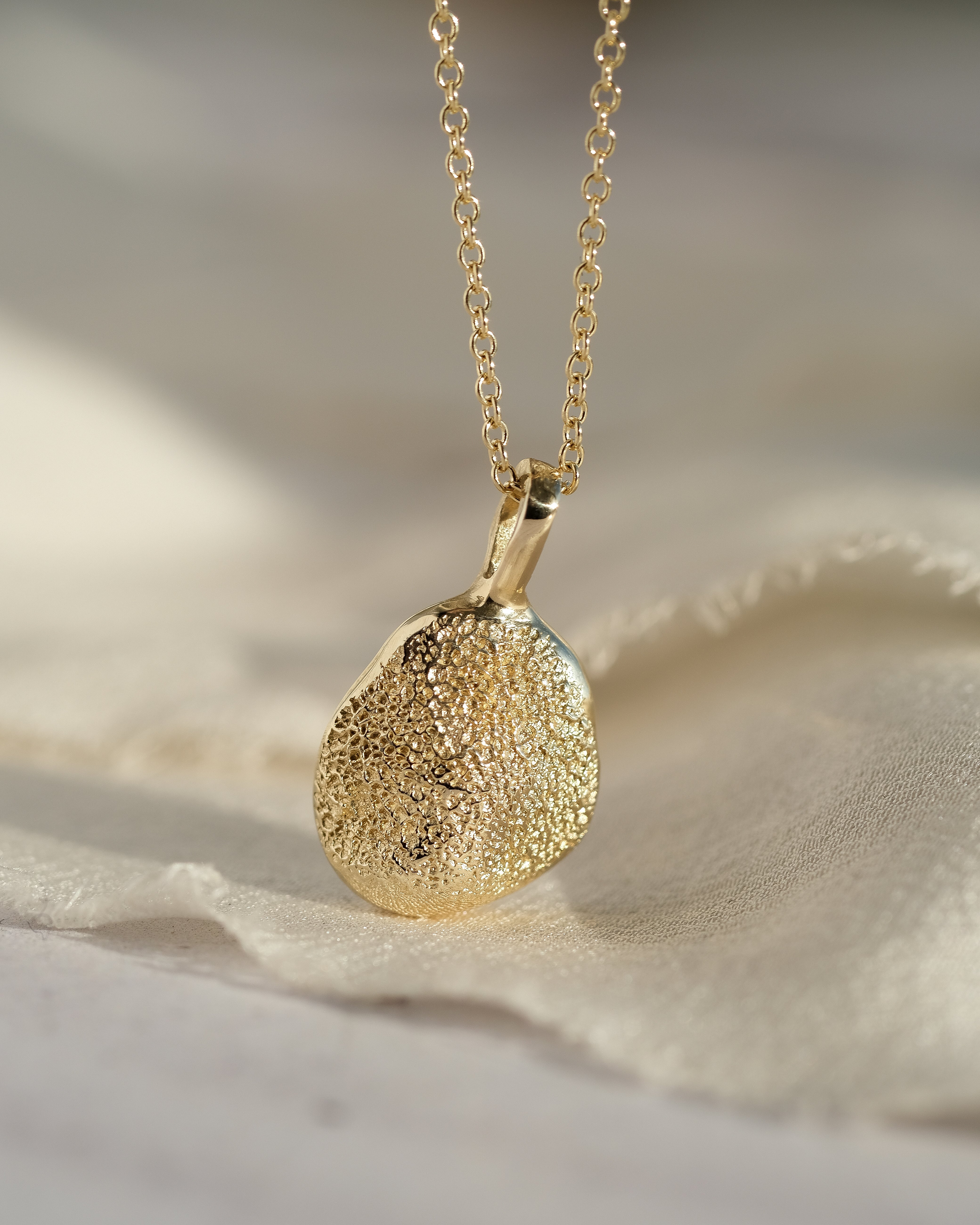 Gold dog paw print necklace