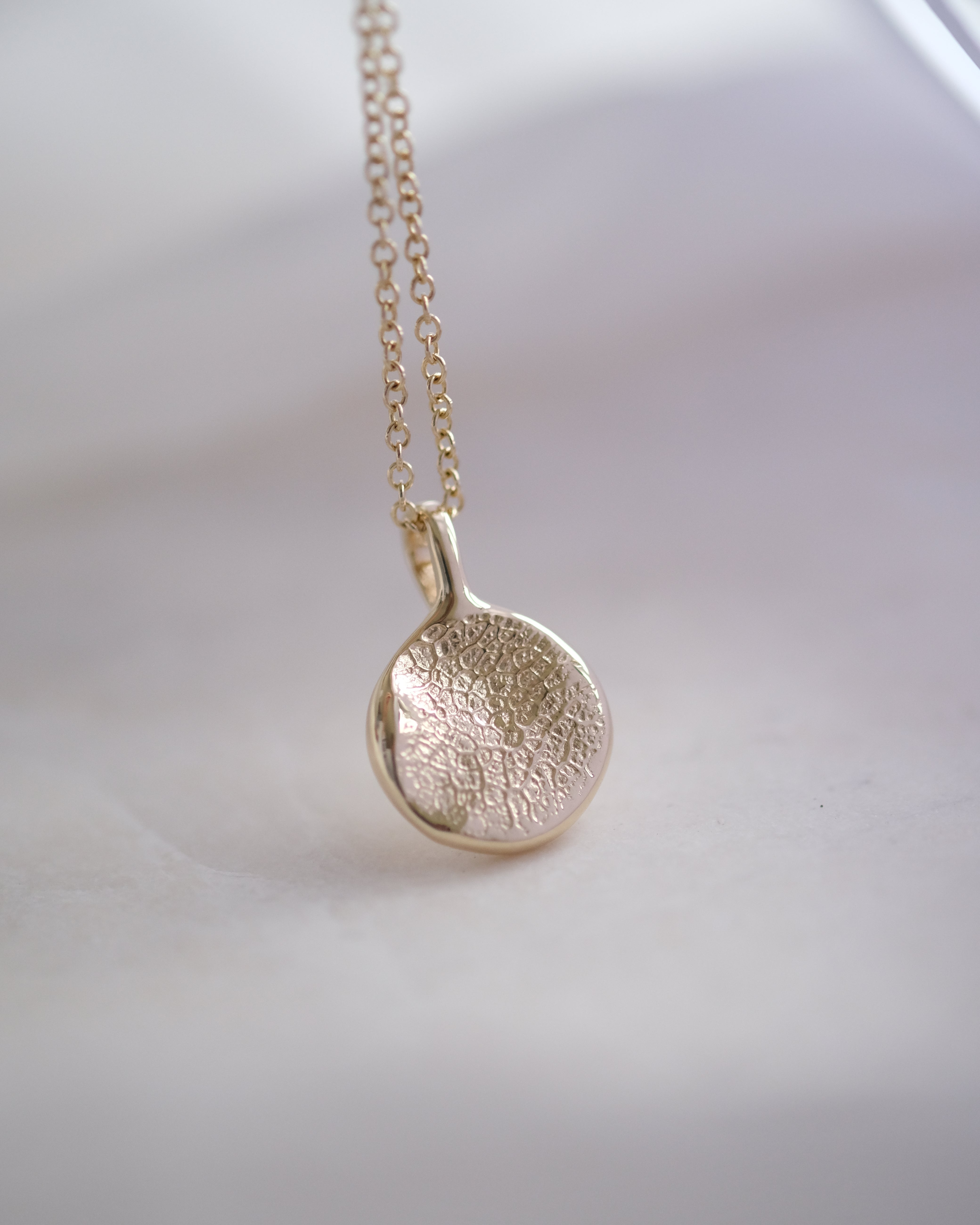 Gold dog nose print necklace