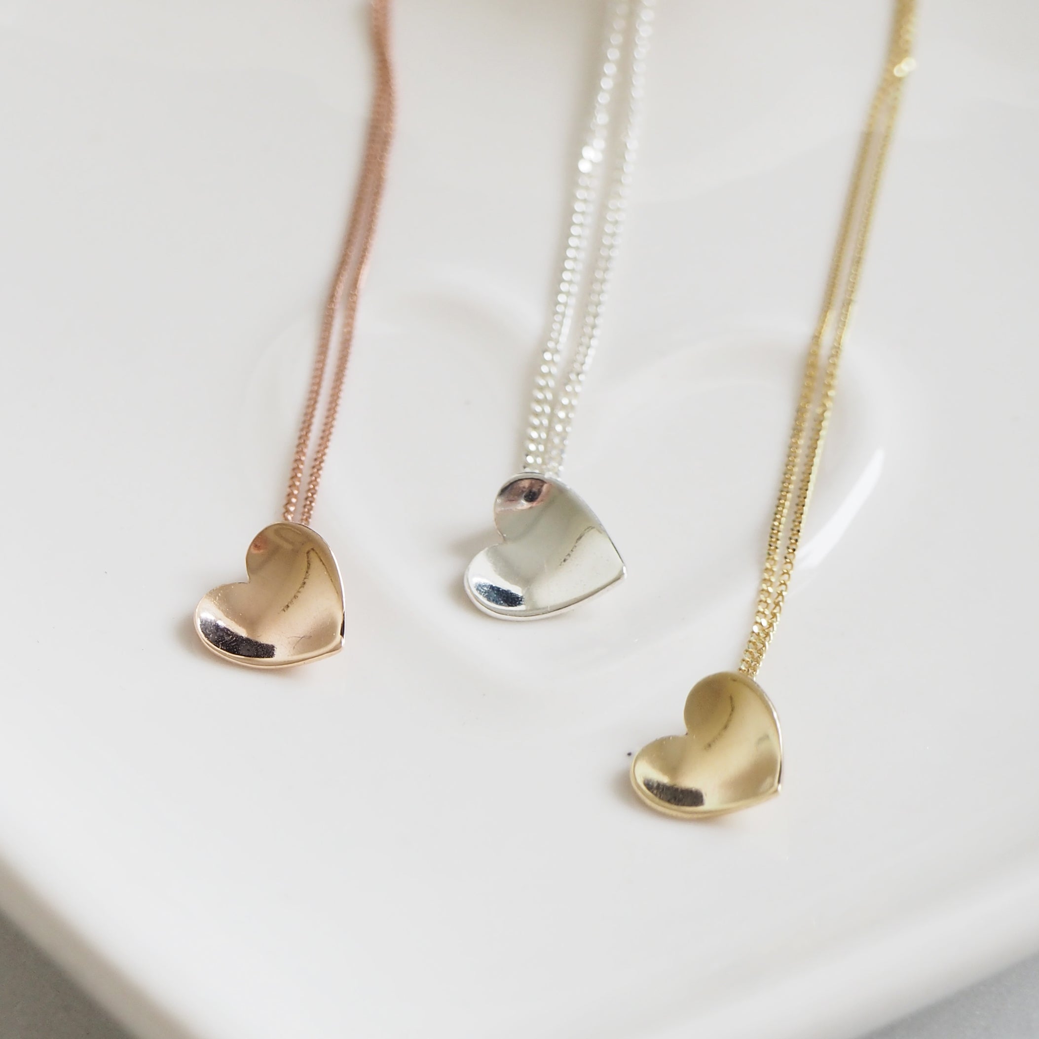 Tiny gold concave heart necklace